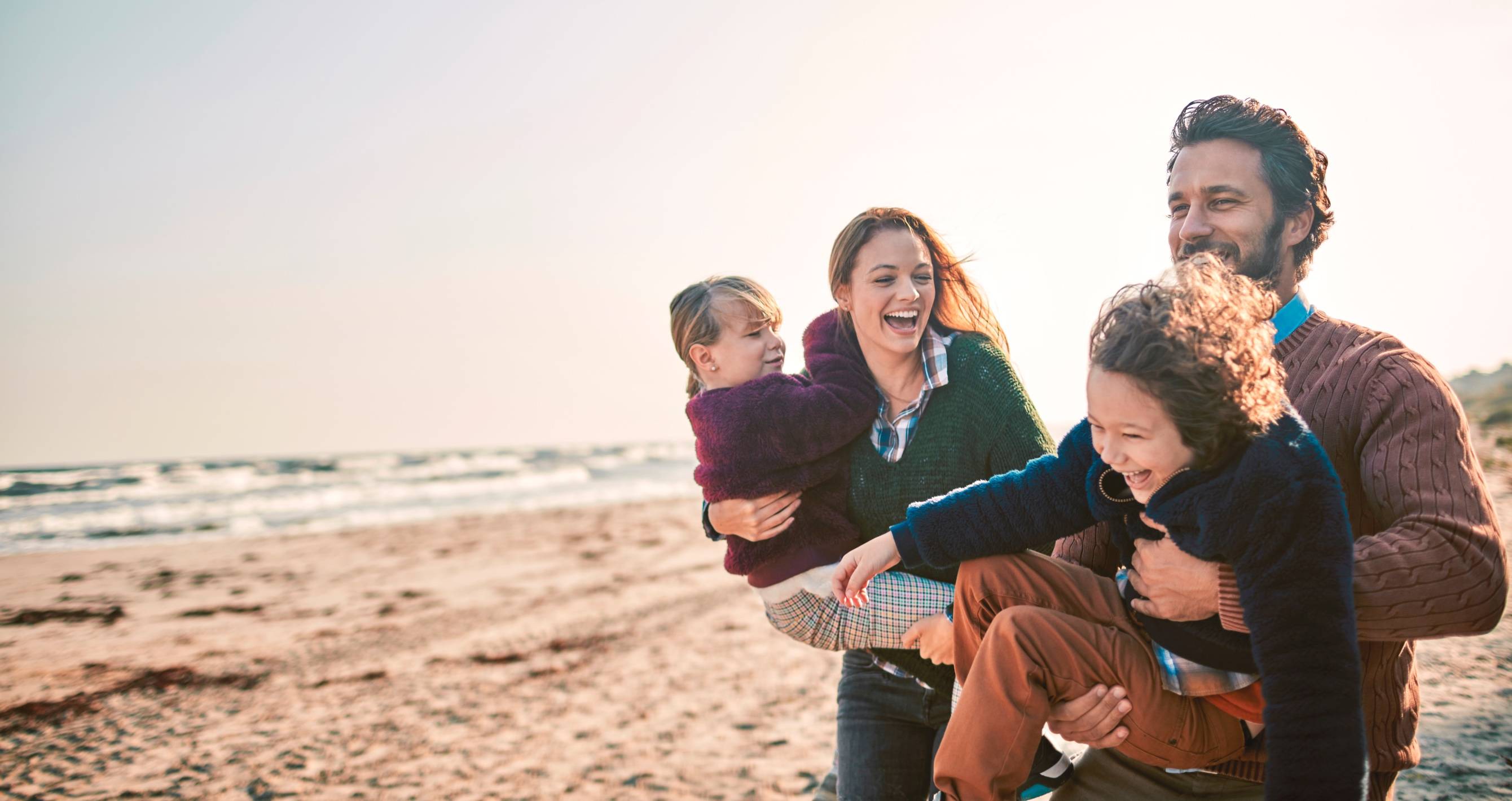 Joyful and active parents and children outdoors